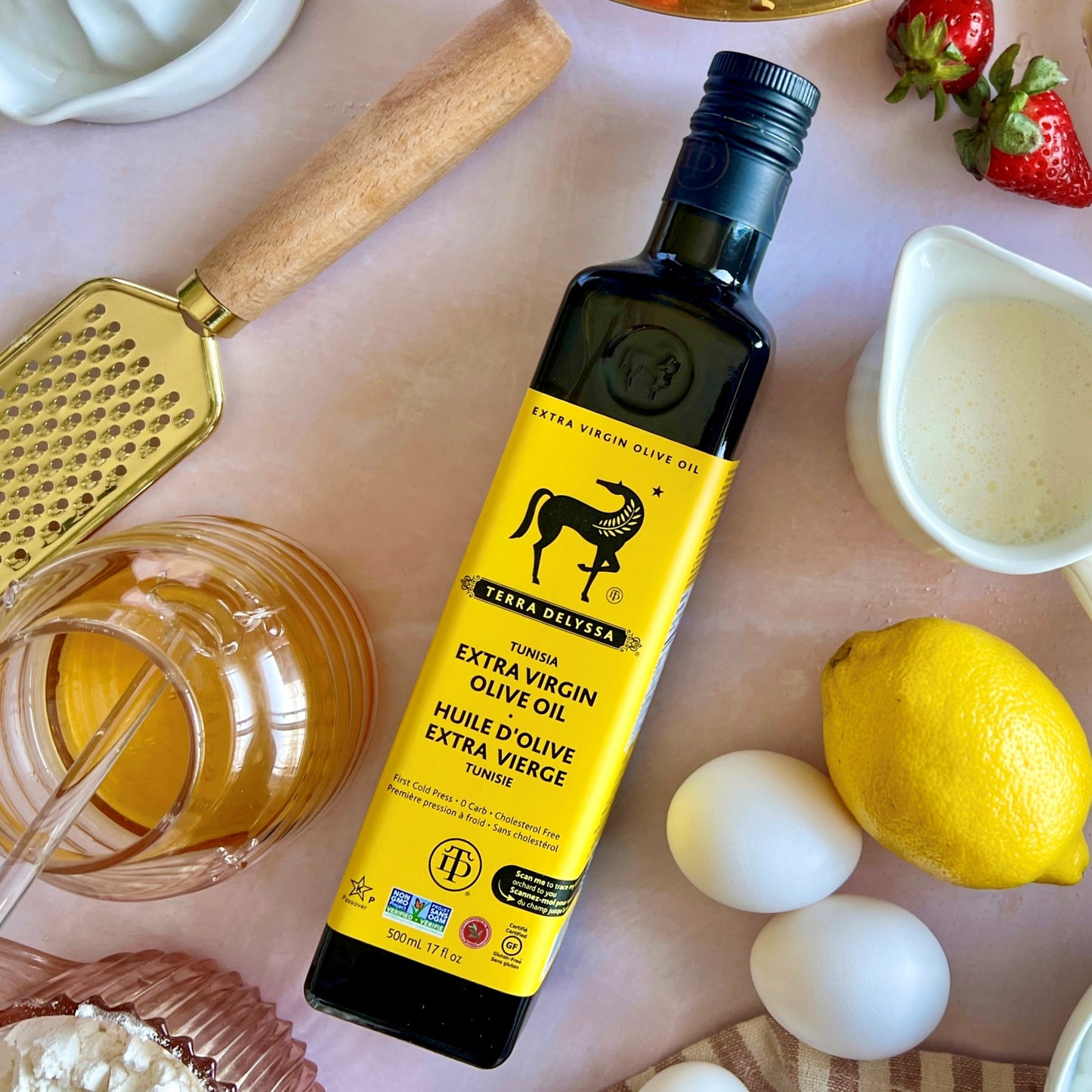 Looking for the perfect ingredients for your Olive Oil and Lemon Cake recipe? Our photo features all the essentials, including granulated sugar, eggs, Terra Delyssa Extra Virgin Olive Oil, Greek yogurt, fresh lemons, flour, baking soda, salt, and fresh strawberries. These high-quality ingredients are sure to make your cake delicious and healthy, with the rich flavor and health benefits of the olive oil and the tangy freshness of the lemons.